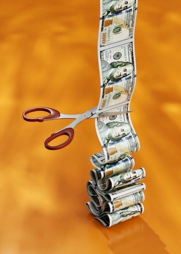 Hidden Cost Concept With Money and Scissors - Hidden Cost of Car Accidents